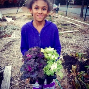 Elyssa, 4th grade student at Southampton Elementary planting purple and green kale. 